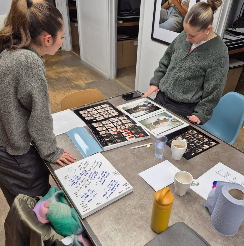 Reviewing contact sheets and prints during a printing workshop